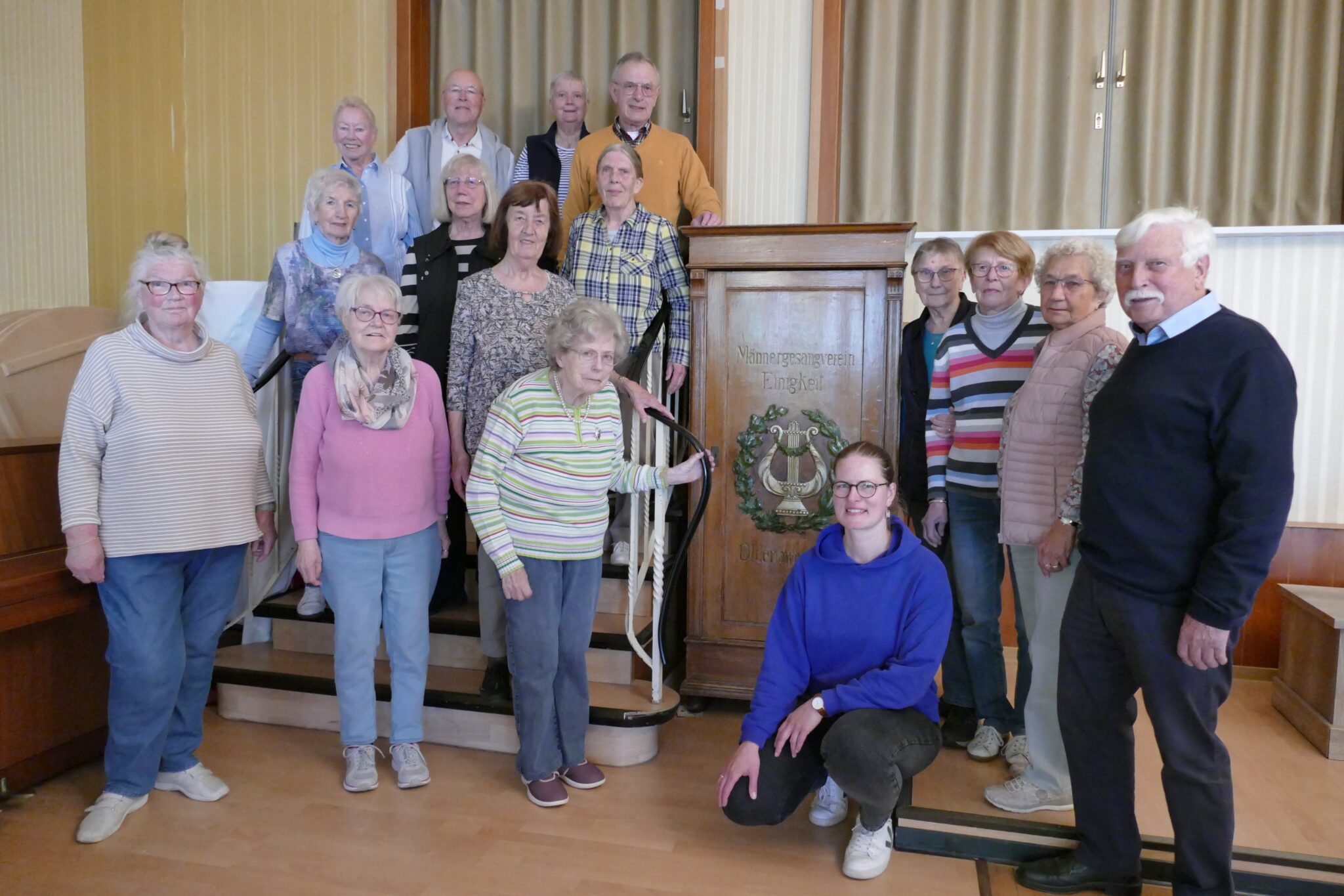 Der Gesangvereins Einigkeit Donnerschwee-Oldenburg e. V. und Sammlungsleiterin Franziska Boegehold-Gude stehen vor dem historischen Notenschrank, © Stadtmuseum Oldenburg Der Gesangvereins Einigkeit Donnerschwee-Oldenburg e. V. und Sammlungsleiterin Franziska Boegehold-Gude stehen vor dem historischen Notenschrank, © Stadtmuseum Oldenburg