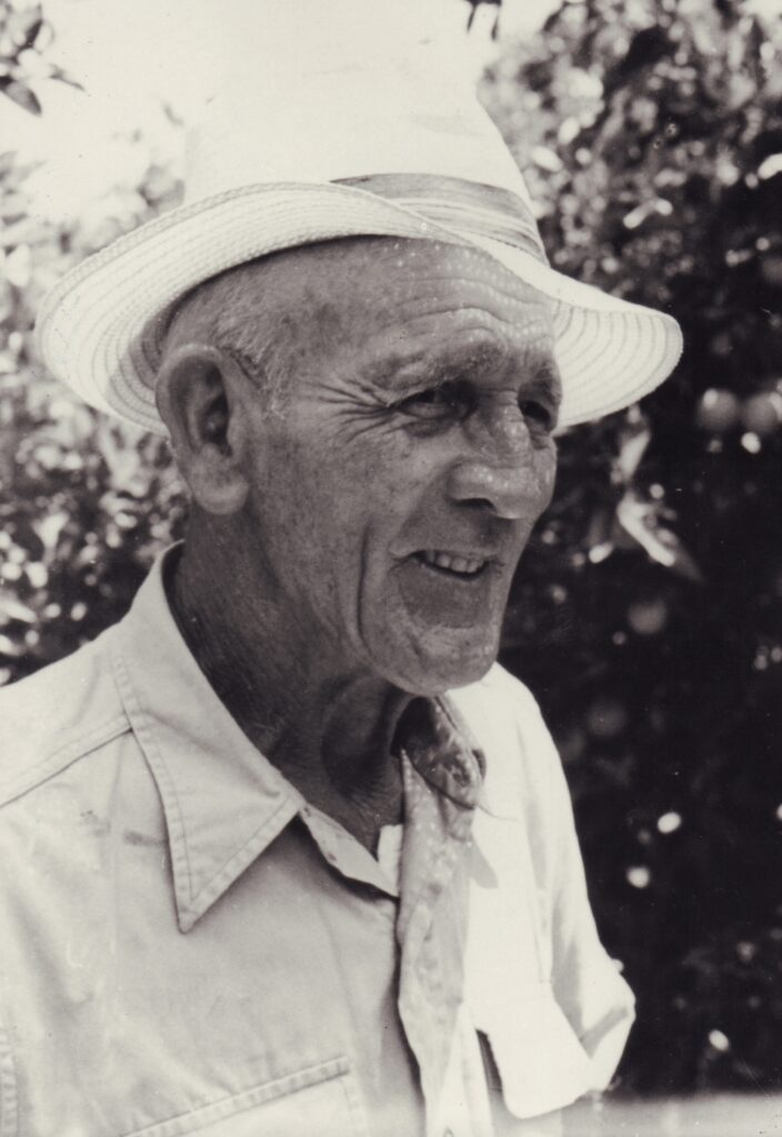 Eine alte Person mit kurzärmligem Hemd und Strohhut lächelt jemanden an, © Stadtmuseum Oldenburg/Slg. Friederichsen